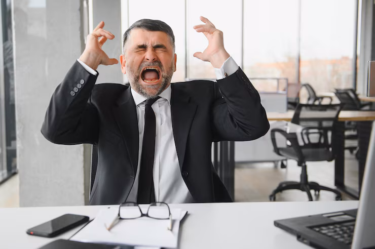angry-businessman-sitting-table-screaming_255667-55158